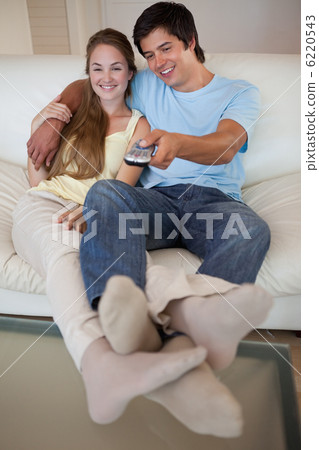 Portrait of a relaxed couple watching television Portrait of a relaxed couple watching television 6220543