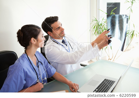 Doctors looking at a set of X-ray Doctors looking at a set of X-ray 6220599