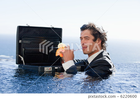 Businessman drinking a cocktail 6220600