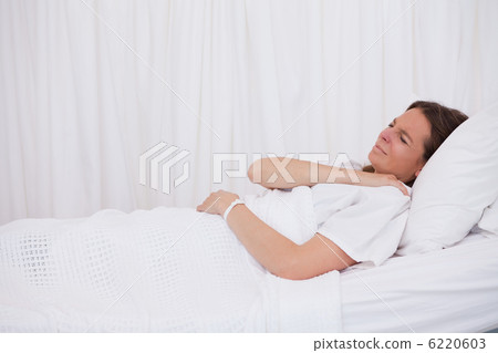 Side view of lying patient covering her shoulder Side view of lying patient covering her shoulder 6220603