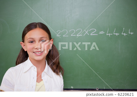 Schoolgirl posing in front of a chalkboard Schoolgirl posing in front of a chalkboard 6220621