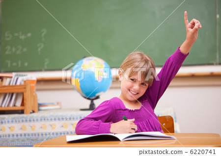 Schoolgirl raising her hand to ask a question Schoolgirl raising her hand to ask a question 6220741