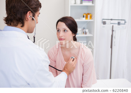 Young doctor taking his patients heart beat 6220840