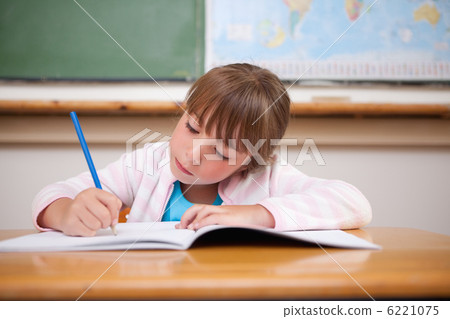 Focused girl writing 6221075