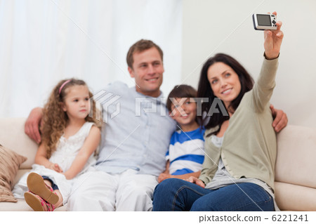 Mother taking a family picture on the couch 6221241