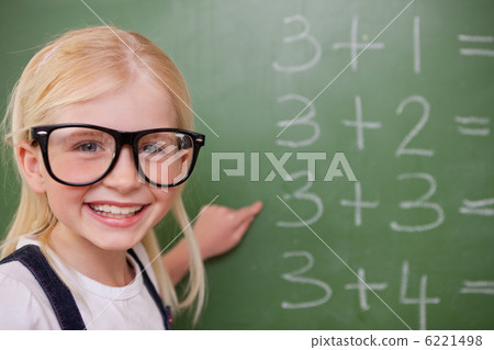 Smart schoolgirl pointing at something Smart schoolgirl pointing at something 6221498