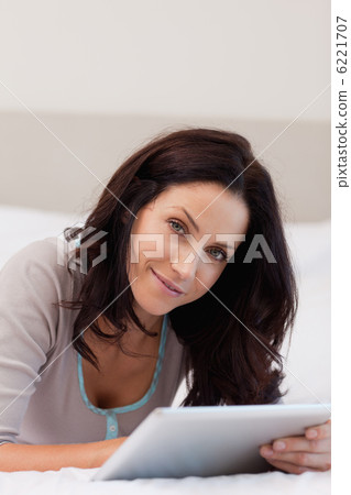Woman in the bedroom using her tablet 6221707
