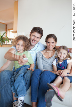 Portrait of a family watching TV together 6221845