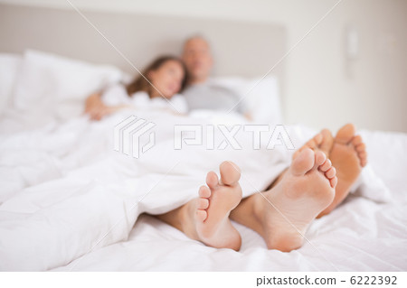 Lovely couple lying in a bed 6222392