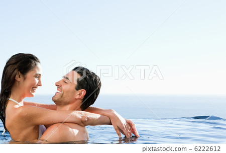 Couple embracing in the pool Couple embracing in the pool 6222612