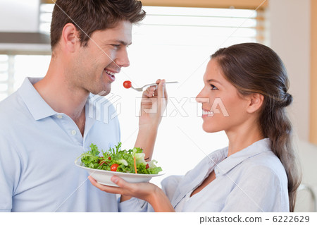 Woman feeding her husband Woman feeding her husband 6222629