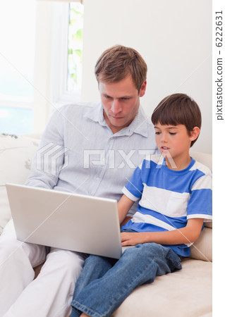 Father and son surfing the internet together 6222631