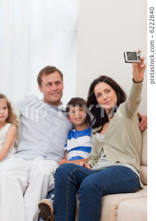 Mother taking family photograph on the sofa 6222640