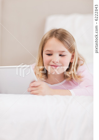 Portrait of a smiling little girl using a tablet computer 6222843