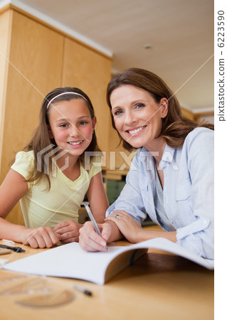Mother helping daughter with homework Mother helping daughter with homework 6223590