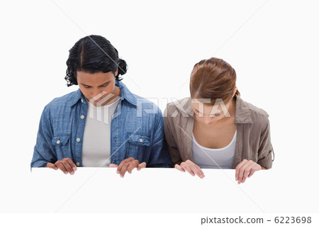 Couple looking down on blank wall 6223698