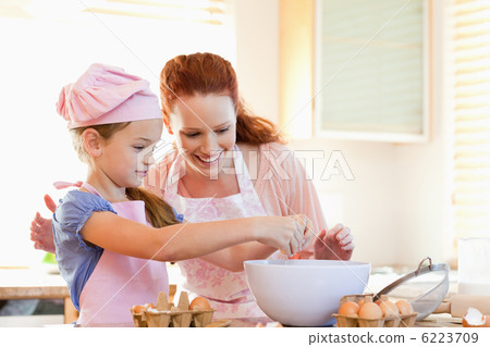 Mother and daughter preparing cookies Mother and daughter preparing cookies 6223709