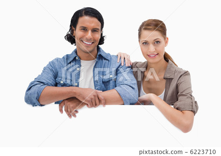 Couple leaning on blank wall Couple leaning on blank wall 6223710