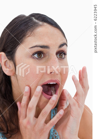 Portrait of a shocked young woman gesturing 6223945