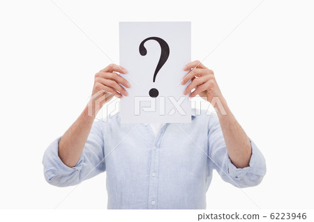 Portrait of a man hiding his face behind a question mark 6223946