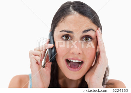 Shocked woman making a phone call 6224163