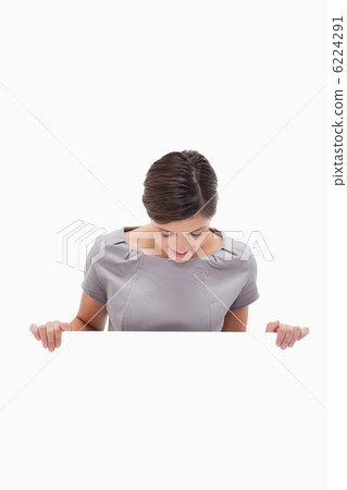 Woman looking down on blank wall 6224291
