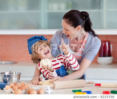 Laughing family having fun in the kitchen 6225356