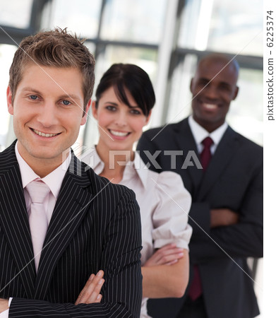 Cheerful business team looking at the camera 6225374