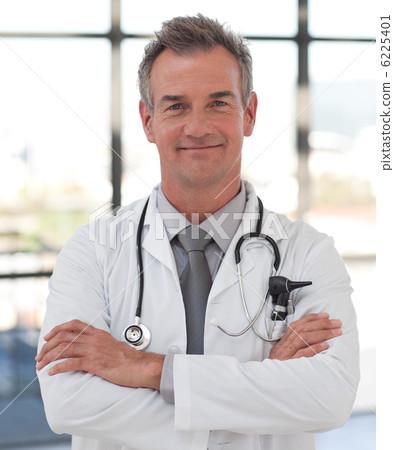 Elderly doctor with folded arms smiling at the camera Elderly doctor with folded arms smiling at the camera 6225401