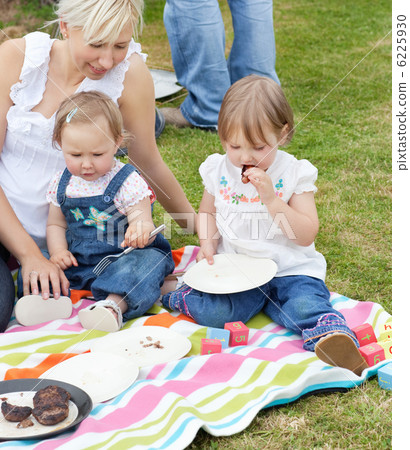 Smiling family having a picnic together Smiling family having a picnic together 6225930