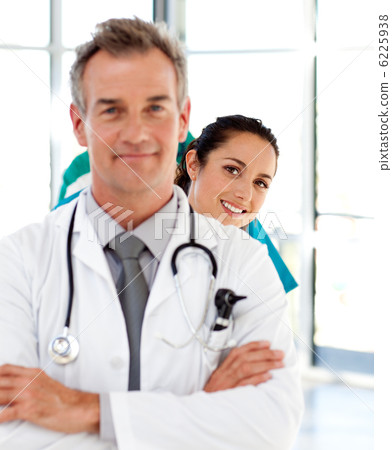 Smiling elderly doctor in the background a young assistance 6225938