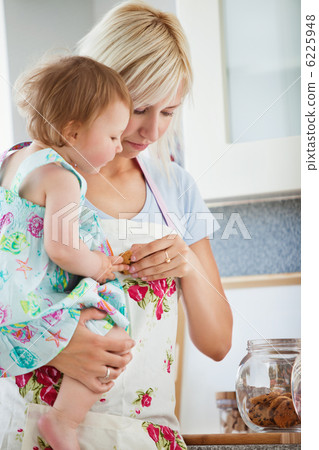 Smiling family having fun iin the kitchen Smiling family having fun iin the kitchen 6225948