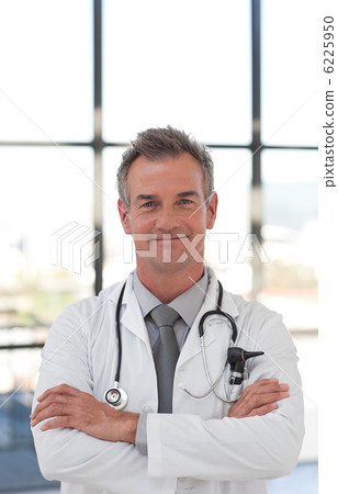 Smiling doctor with folded arms Smiling doctor with folded arms 6225950