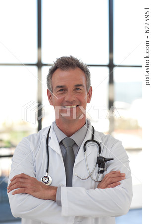 Charismatic doctor  smiling at the camera 6225951