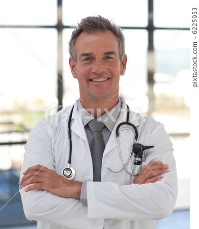 Smiling doctor with folded arms Smiling doctor with folded arms 6225953