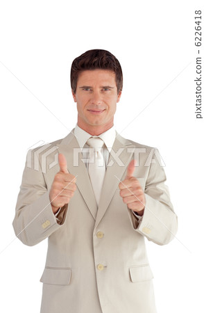 positive businessman making a thumb-up positive businessman making a thumb-up 6226418