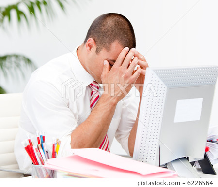 Frustrated businessman working at a computer Frustrated businessman working at a computer 6226564