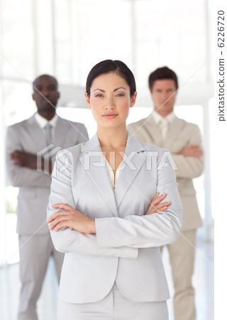 Delighted asian businesswoman standing at the camera with arms f 6226720