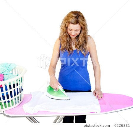 Glowing woman ironing her clothes on a ironing board 6226881