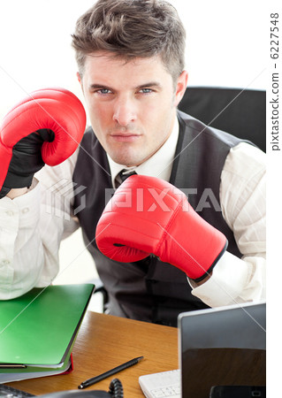 Angry businessman wearing boxing gloves 6227548