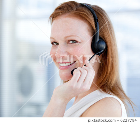 Smiling sales representative woman with an headset 6227794