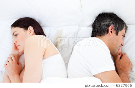 Upset couple sleeping in their bed separately 6227966