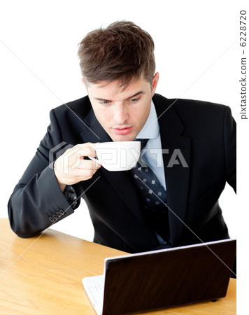 Stressed young businesswoman drinking coffee and using his lapto Stressed young businesswoman drinking coffee and using his lapto 6228720