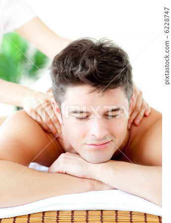 Portrait of a handsome man having a back massage Portrait of a handsome man having a back massage 6228747