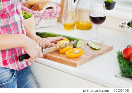 Close-up of a woman cutting paprika at home Close-up of a woman cutting paprika at home 6229408