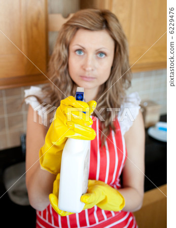 Beautiful blond woman holding cleansing agent into the camera 6229476