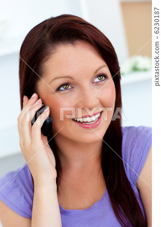 Merry woman using her cellphone at home Merry woman using her cellphone at home 6230187