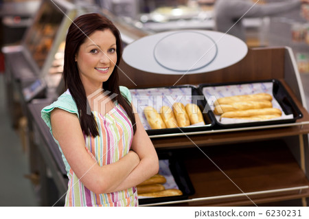 Self-assured female cook smiling at the camera Self-assured female cook smiling at the camera 6230231