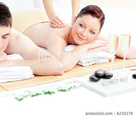 Loving young couple enjoying a back massage Loving young couple enjoying a back massage 6230276