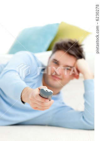 Caucasian young man watching tv in the living-room 6230278